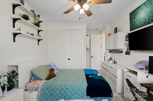 a bedroom with a bed and a chandelier