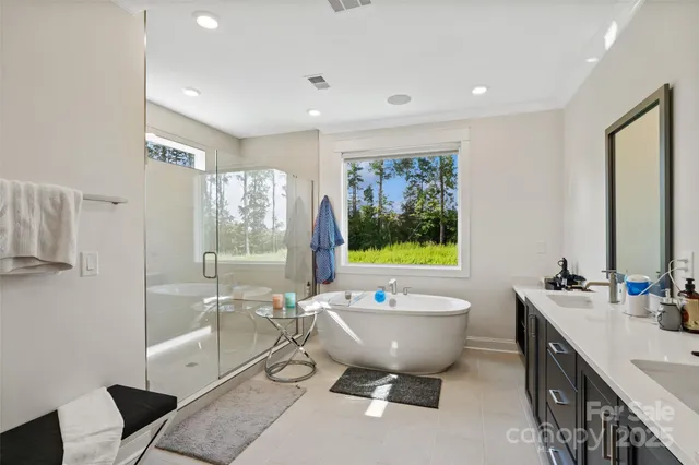 a bath tub sitting next to a bathroom sink