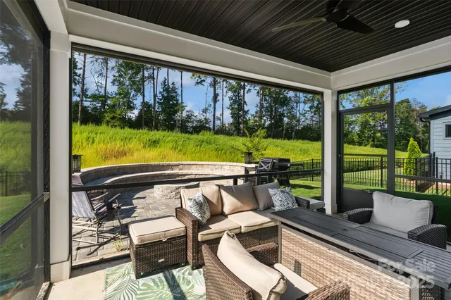 a view of a house with swimming pool and furniture