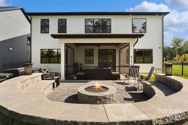 a swimming pool with outdoor seating and yard