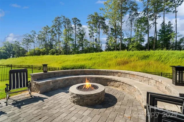 a view of a house with swimming pool and a yard