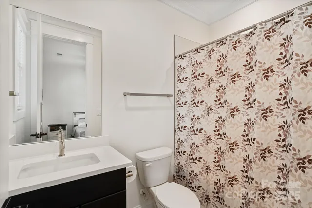 a room with lots of books and a dining table