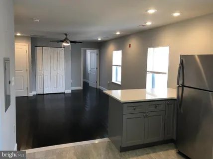 a kitchen with a refrigerator and a sink