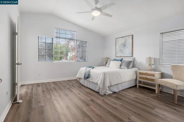 a bedroom with a bed and windows