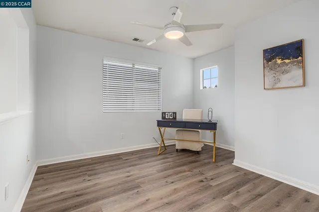 a view of a workspace with wooden floor