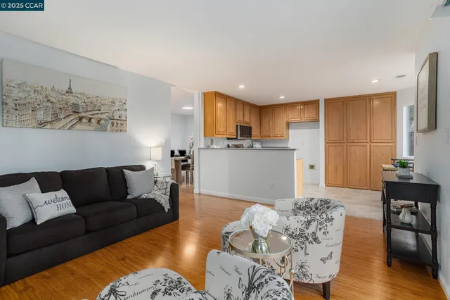 a living room with furniture and kitchen view