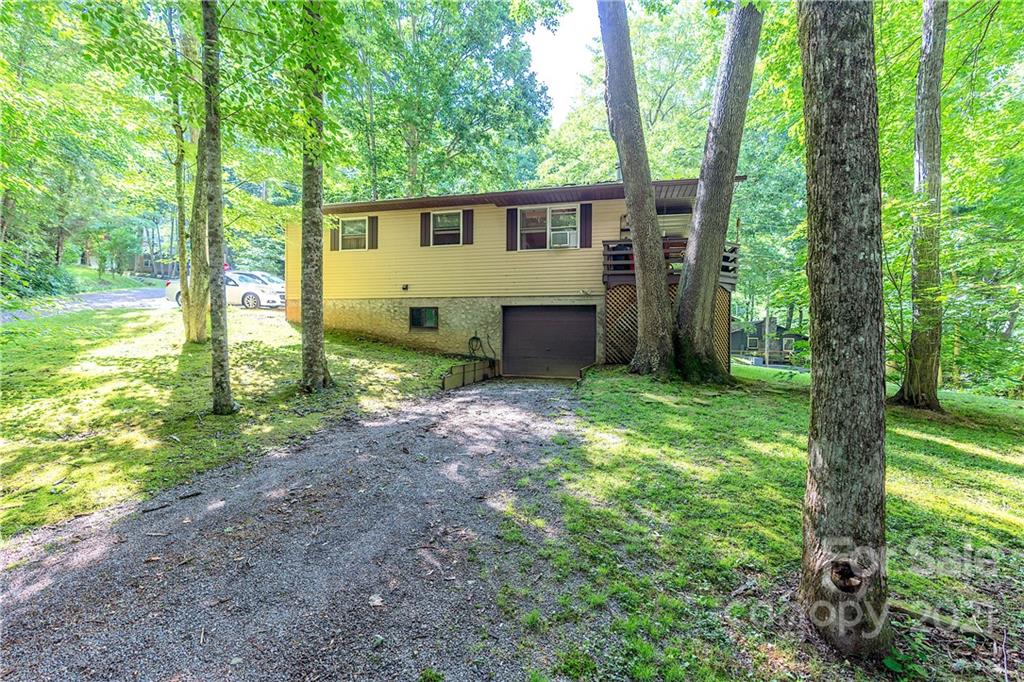 165 Nottingham Road Maggie Valley, NC 28751 - Photo 1 of 29 a view of a house with backyard and a tree
