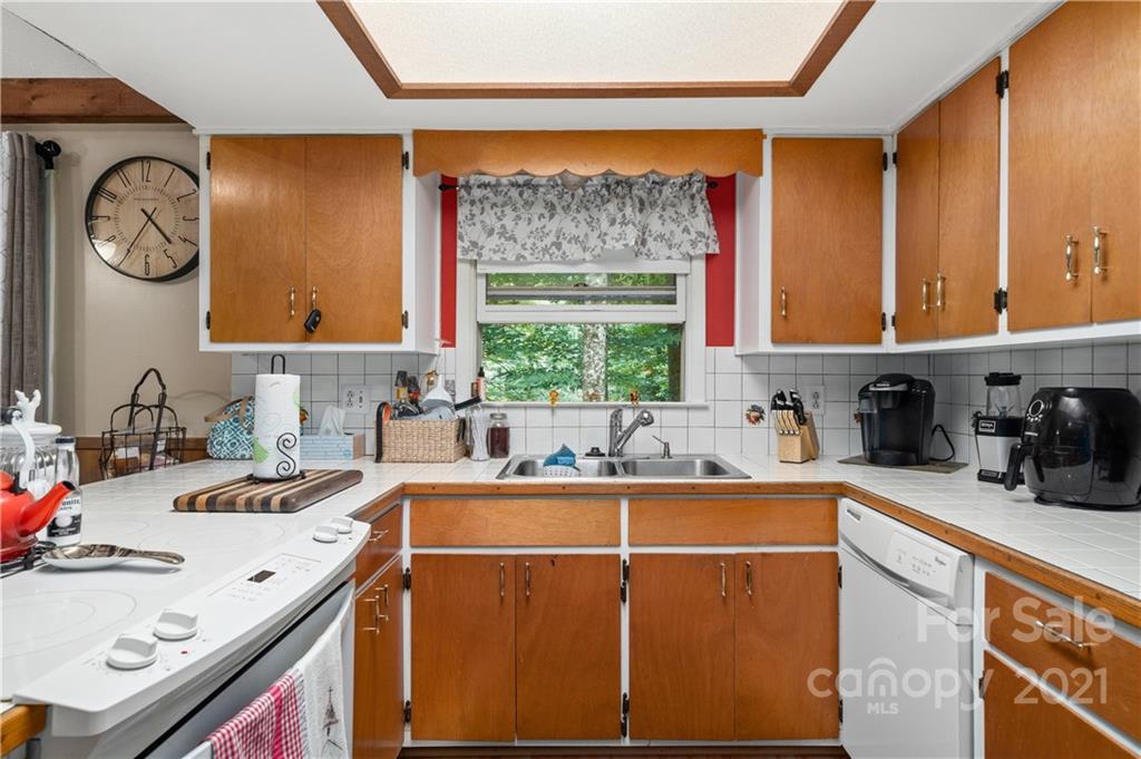 165 Nottingham Road Maggie Valley, NC 28751 - Photo 12 of 29 a kitchen with a sink a stove and a refrigerator