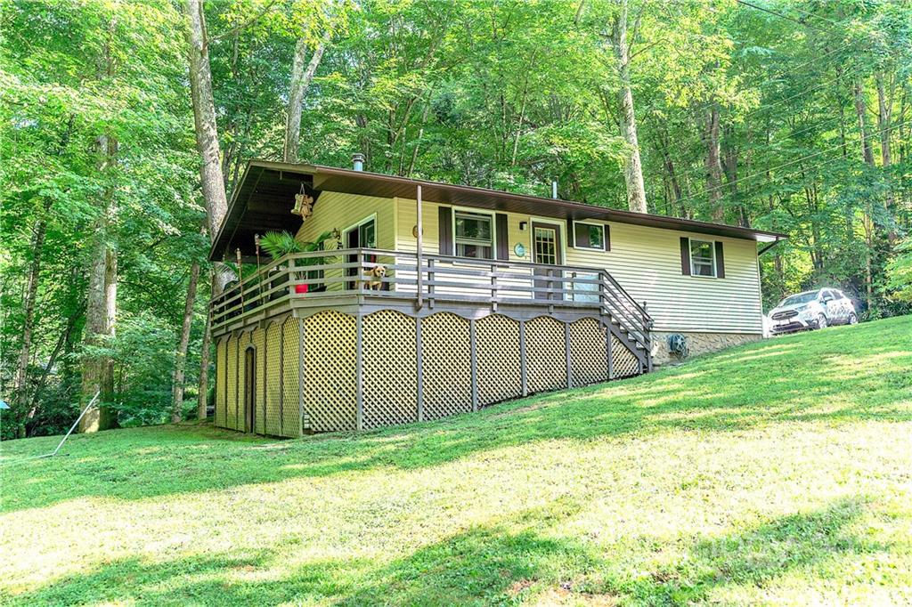 165 Nottingham Road Maggie Valley, NC 28751 - Photo 6 of 29 a front view of house with yard and trees in the background