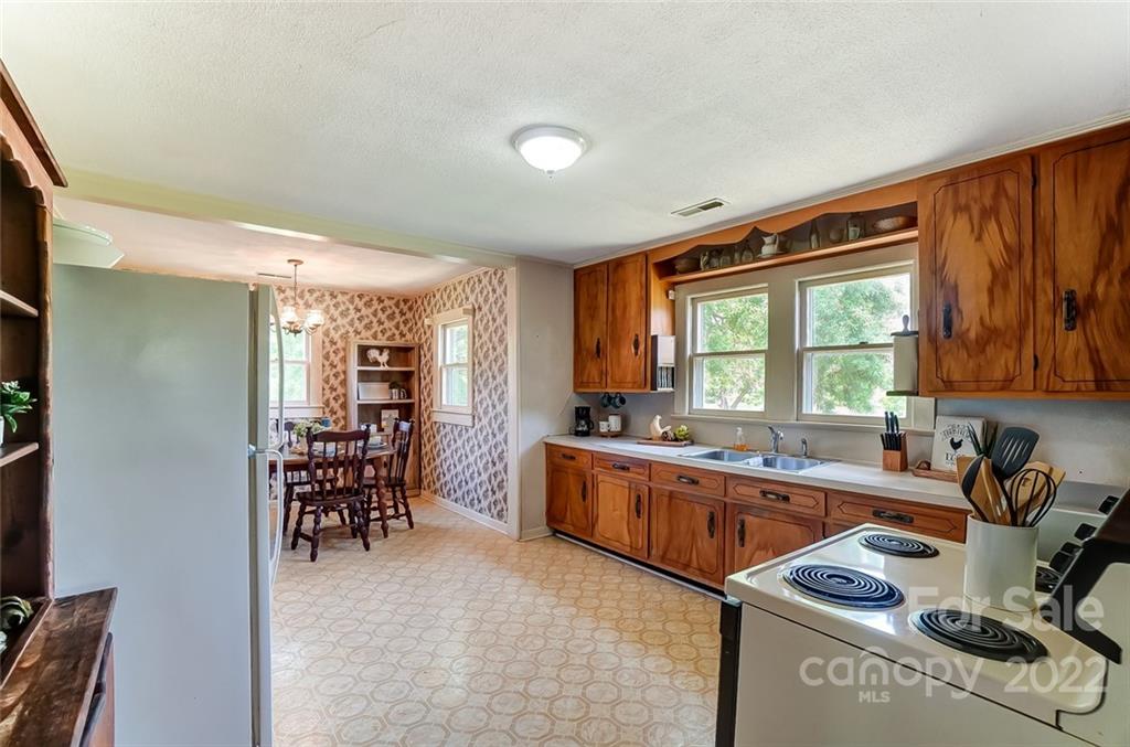 715 Clontz Long Road Monroe, NC 28110 - Photo 13 of 34 a kitchen with granite countertop a sink stove and cabinets