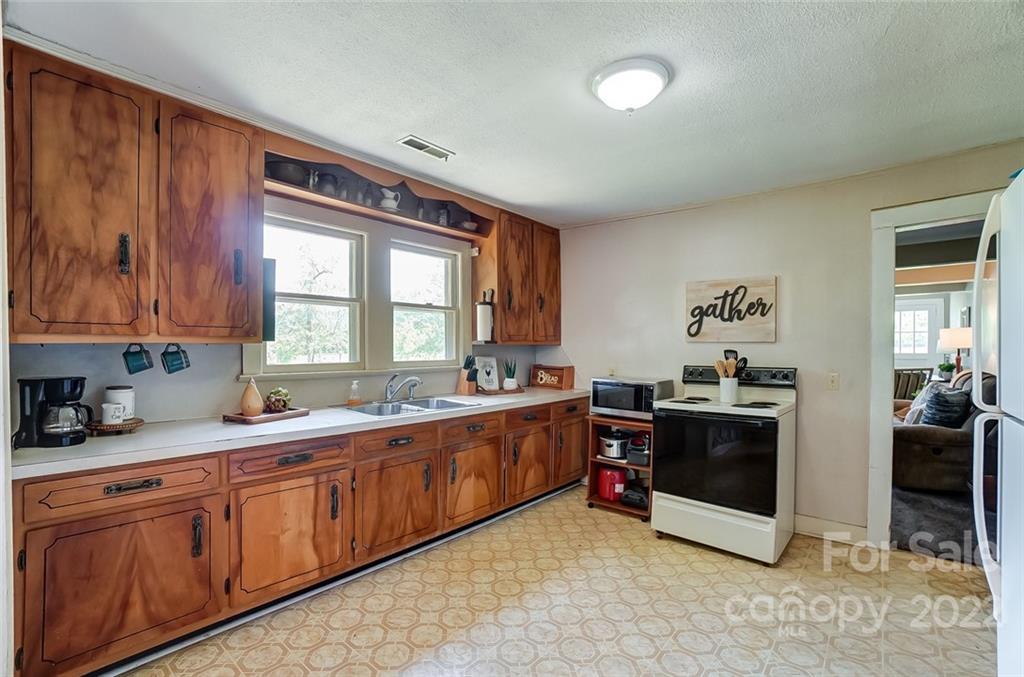 715 Clontz Long Road Monroe, NC 28110 - Photo 14 of 34 a large kitchen with stainless steel appliances granite countertop a sink and cabinets