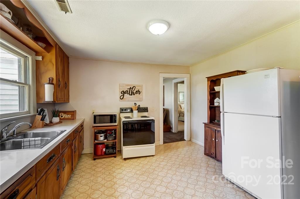 715 Clontz Long Road Monroe, NC 28110 - Photo 15 of 34 a kitchen with a refrigerator and a sink