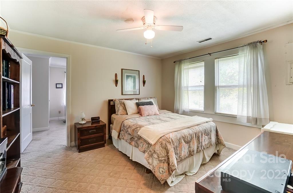715 Clontz Long Road Monroe, NC 28110 - Photo 21 of 34 a bedroom with a bed and a chandelier
