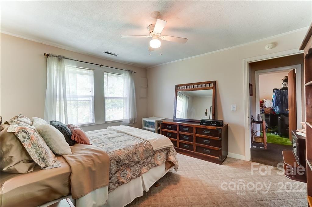 715 Clontz Long Road Monroe, NC 28110 - Photo 23 of 34 a bedroom with a bed and a dresser