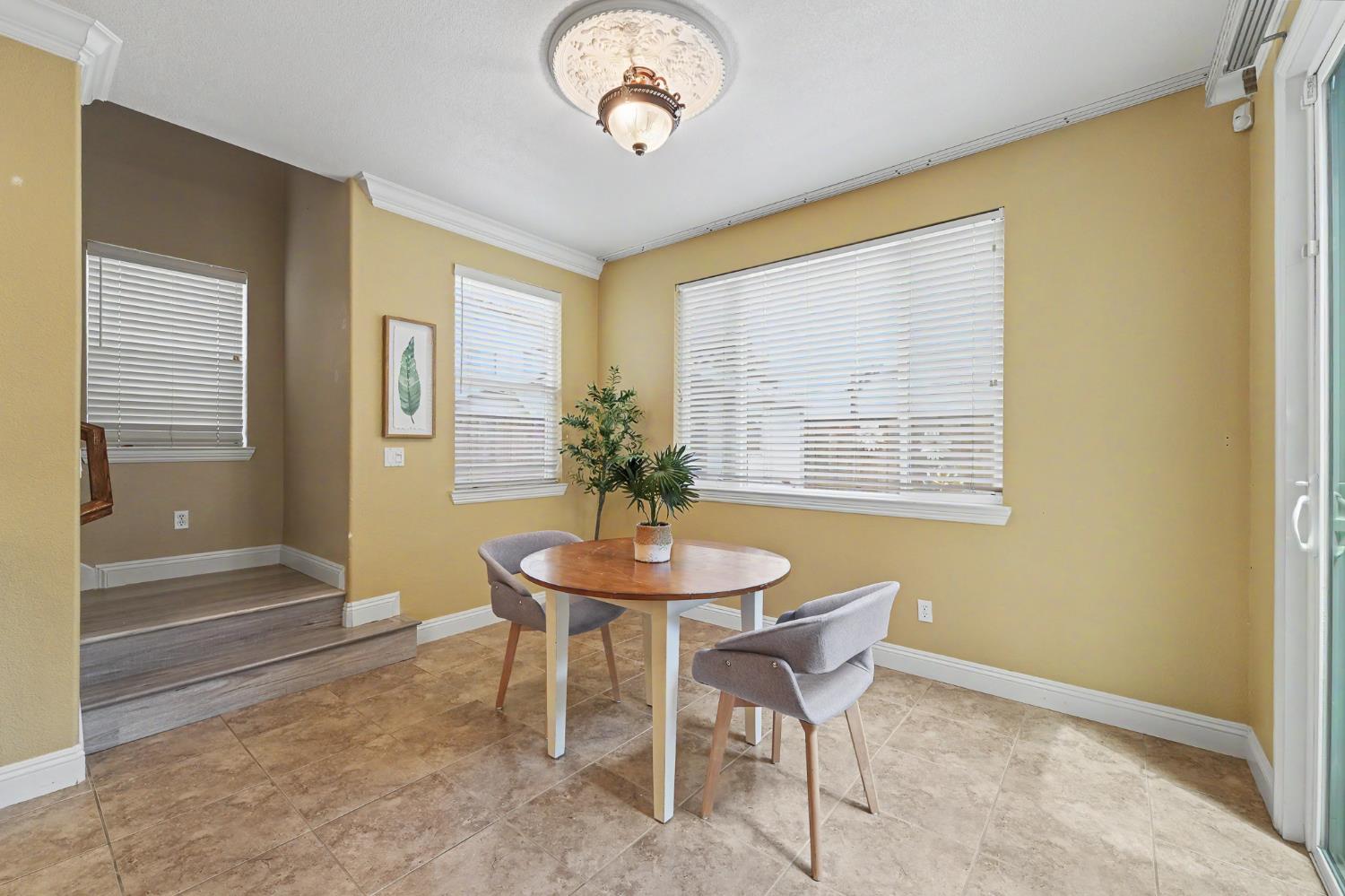 1223 East Springer Drive Turlock, CA 95382 - Photo 21 of 48 a dining room with chandelier and wooden floor