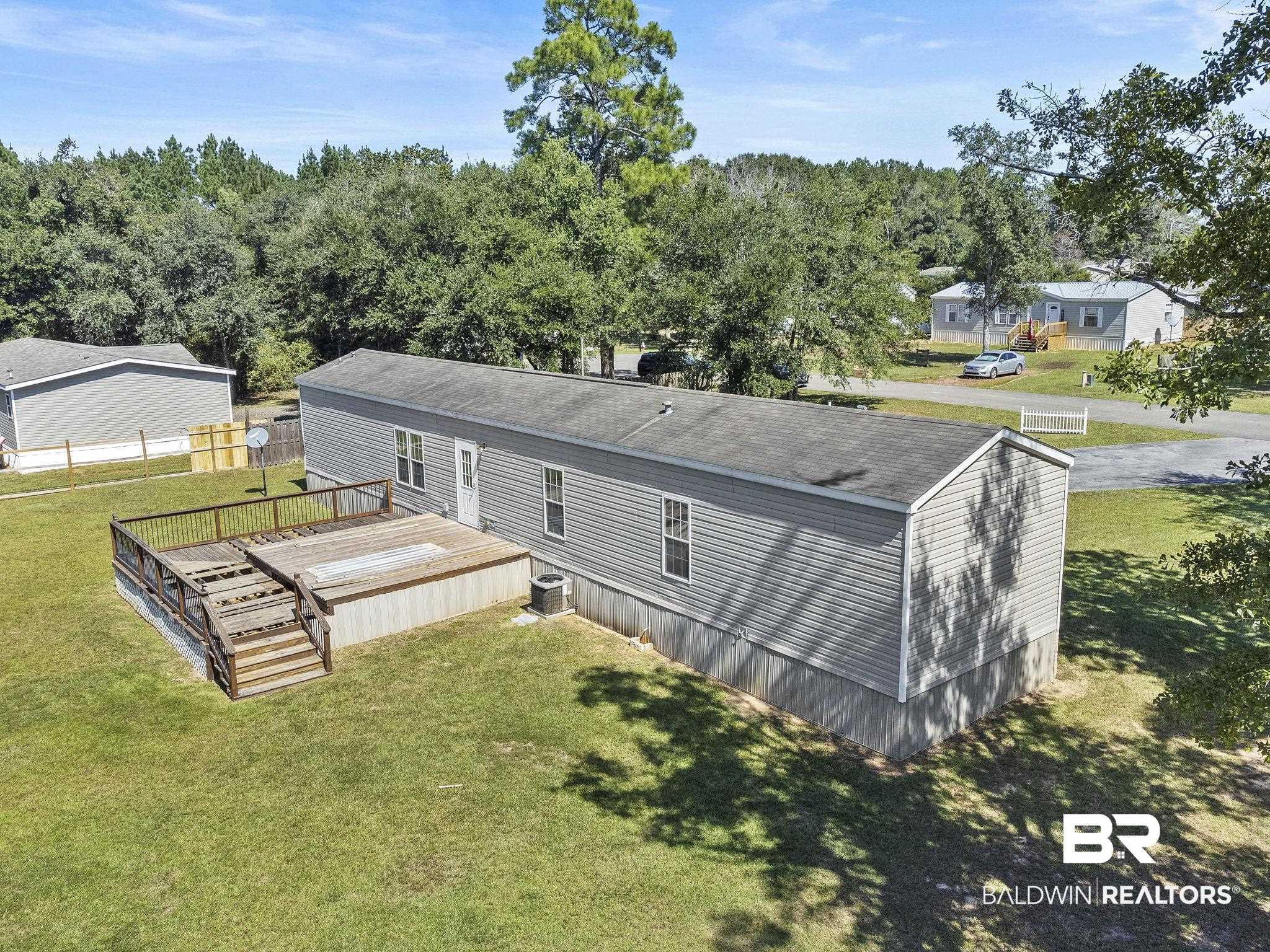 6870 Cecilia Court Theodore, AL 36582 - Photo 72 of 83 Back of property with cooling unit and a yard