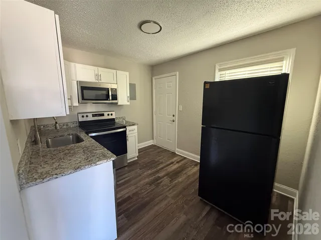 a kitchen with a refrigerator and a sink