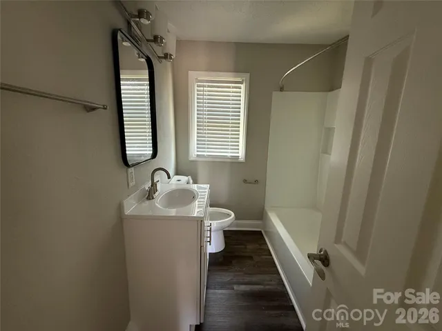a bathroom with double sink and mirror with bathtub