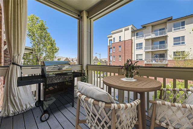 a view of a chairs and table in the balcony