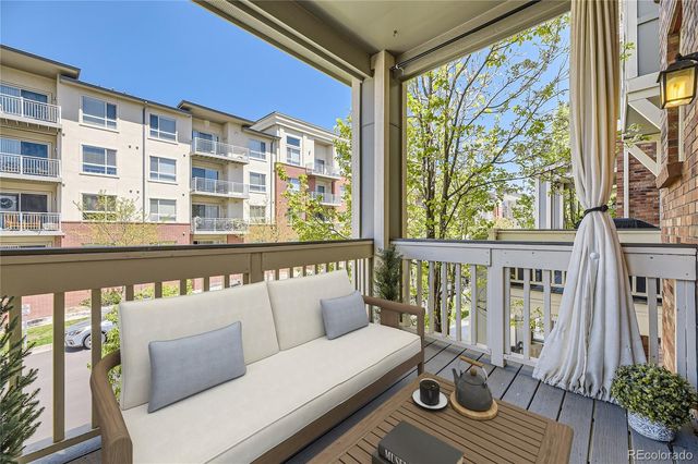 a balcony view with a seating space