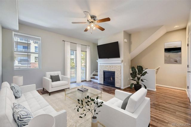 a living room with furniture a fireplace and a flat screen tv