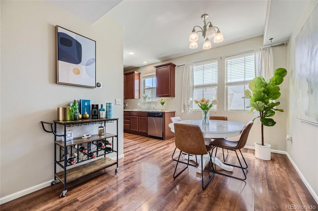 a view of a a dining room with furniture window and wooden floor