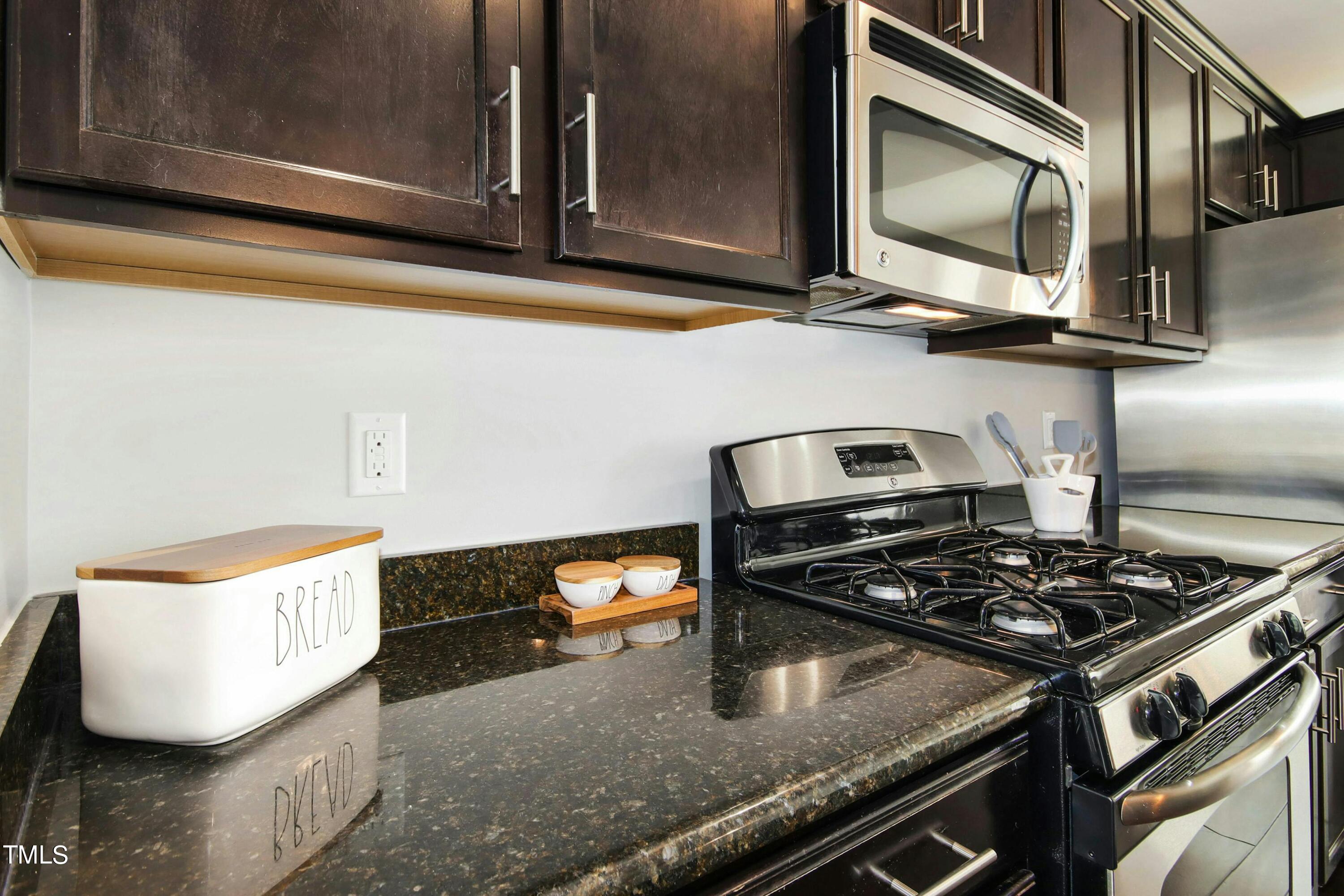 1418 Ardara Lane Raleigh, NC 27607 - Photo 11 of 34 a kitchen with a stove and a microwave