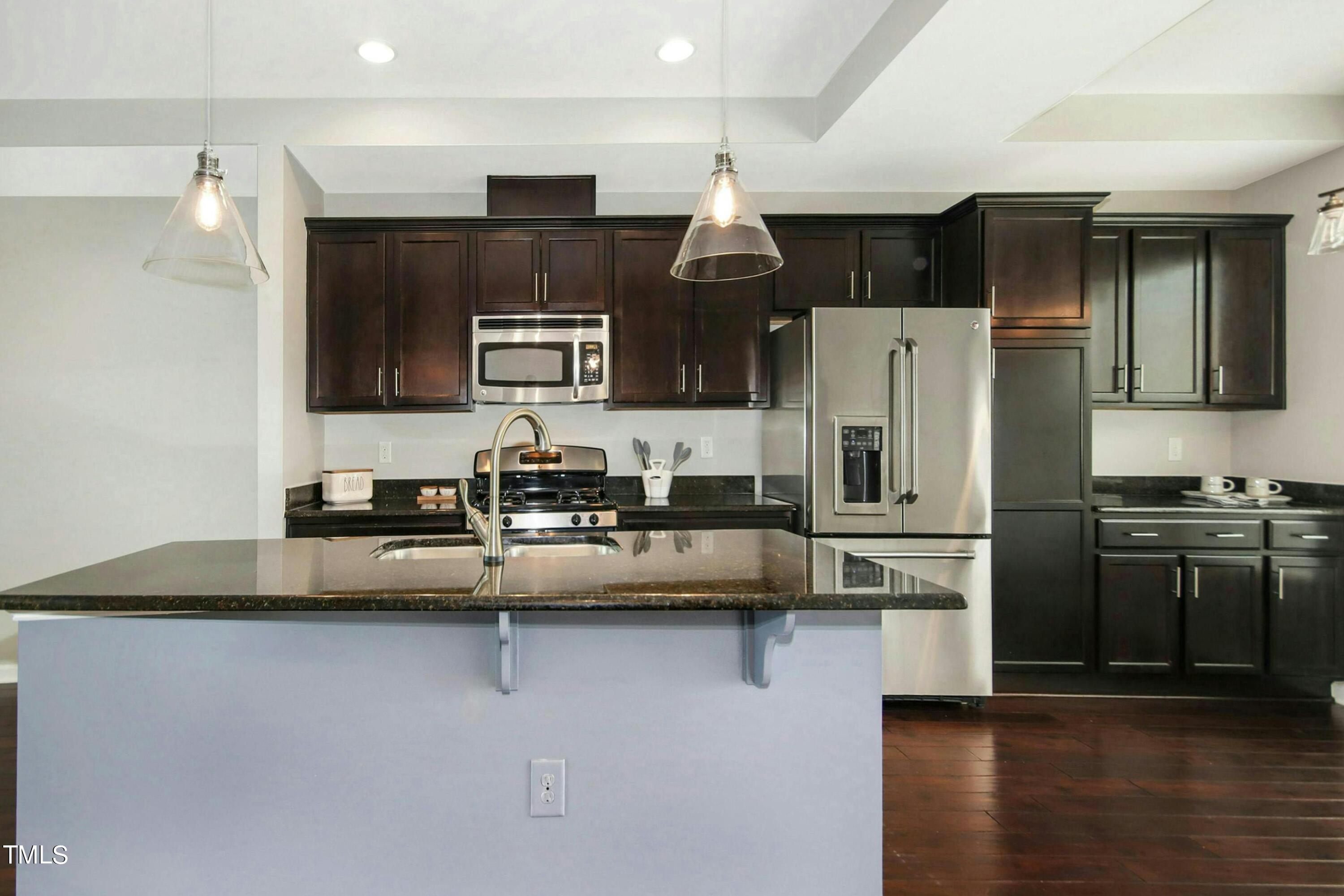 1418 Ardara Lane Raleigh, NC 27607 - Photo 13 of 34 a kitchen with stainless steel appliances a refrigerator and a stove top oven