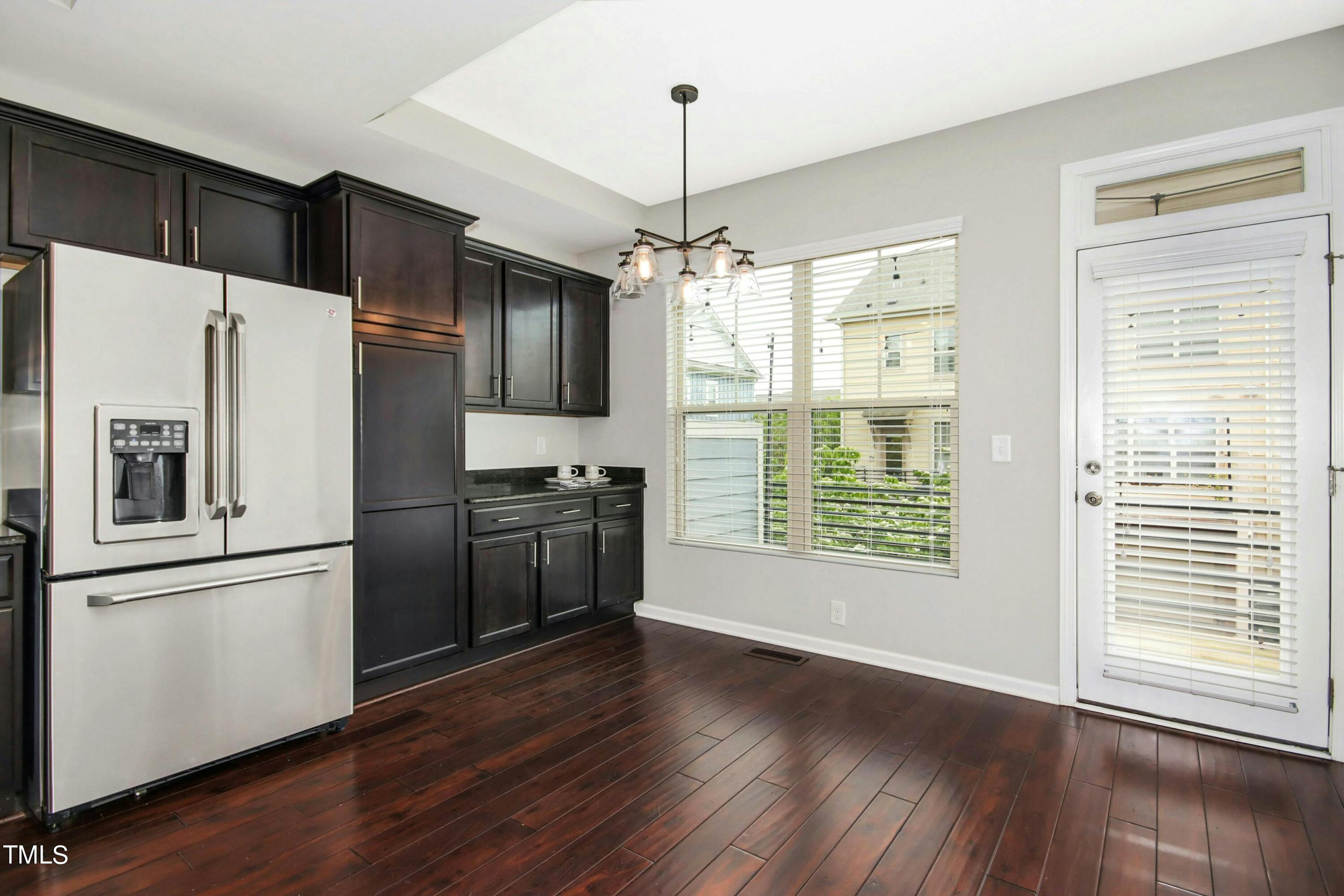 1418 Ardara Lane Raleigh, NC 27607 - Photo 14 of 34 a kitchen with stainless steel appliances a refrigerator and wooden floor