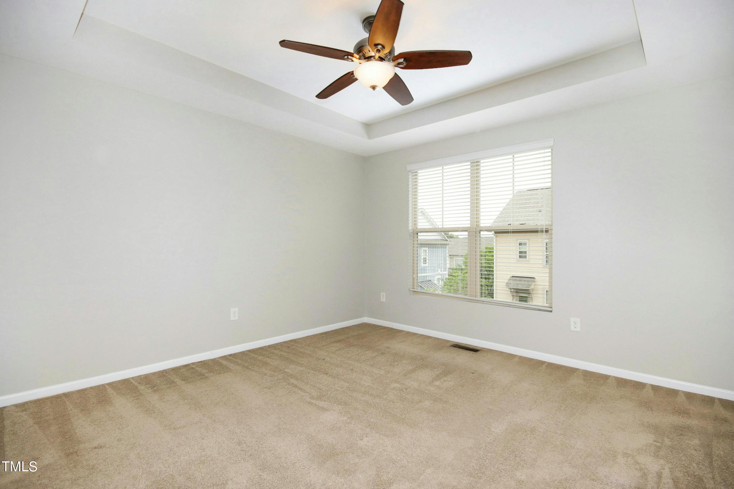 1418 Ardara Lane Raleigh, NC 27607 - Photo 18 of 34 an empty room with a window and a ceiling fan