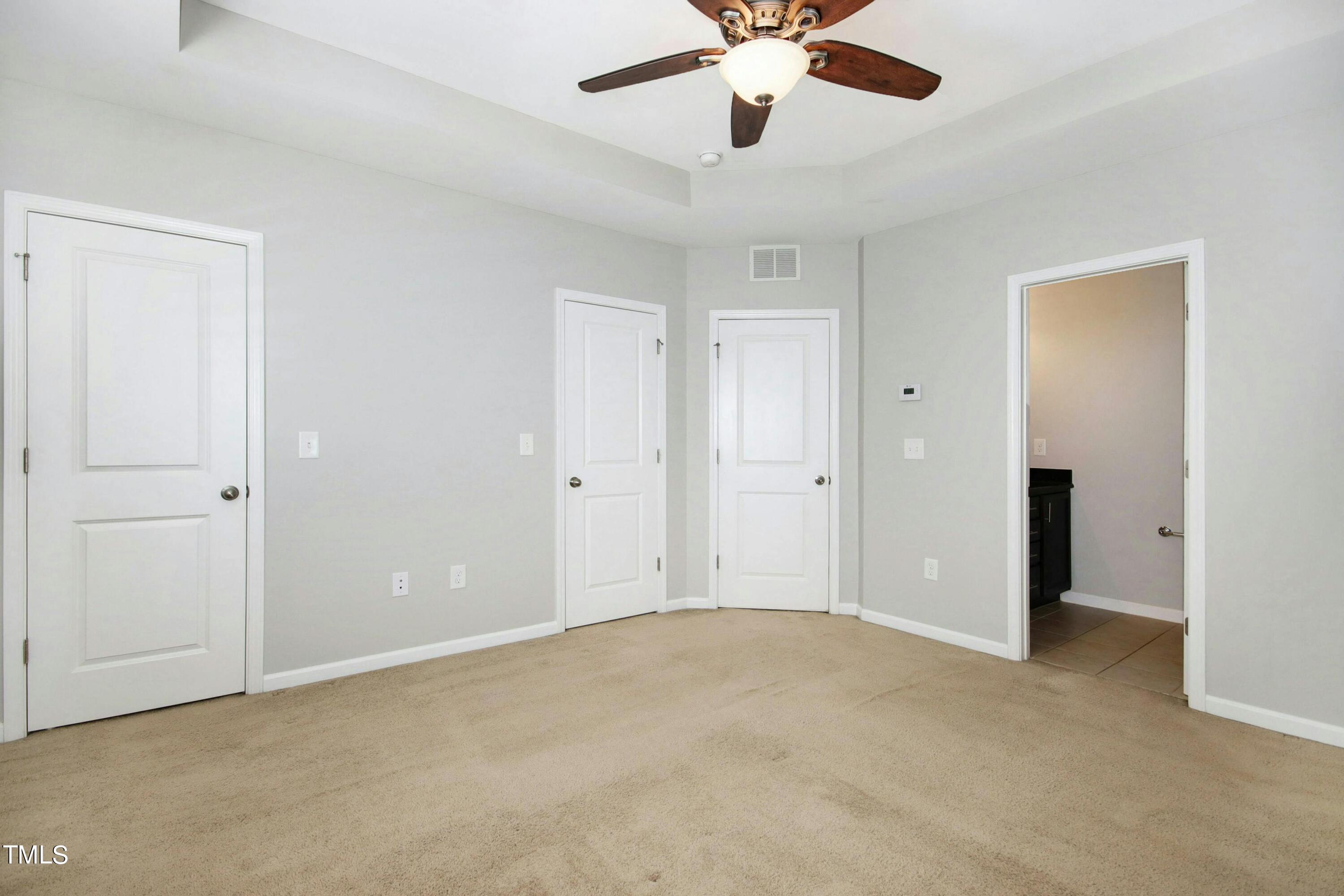 1418 Ardara Lane Raleigh, NC 27607 - Photo 20 of 34 an empty room with a chandelier fan and a ceiling fan