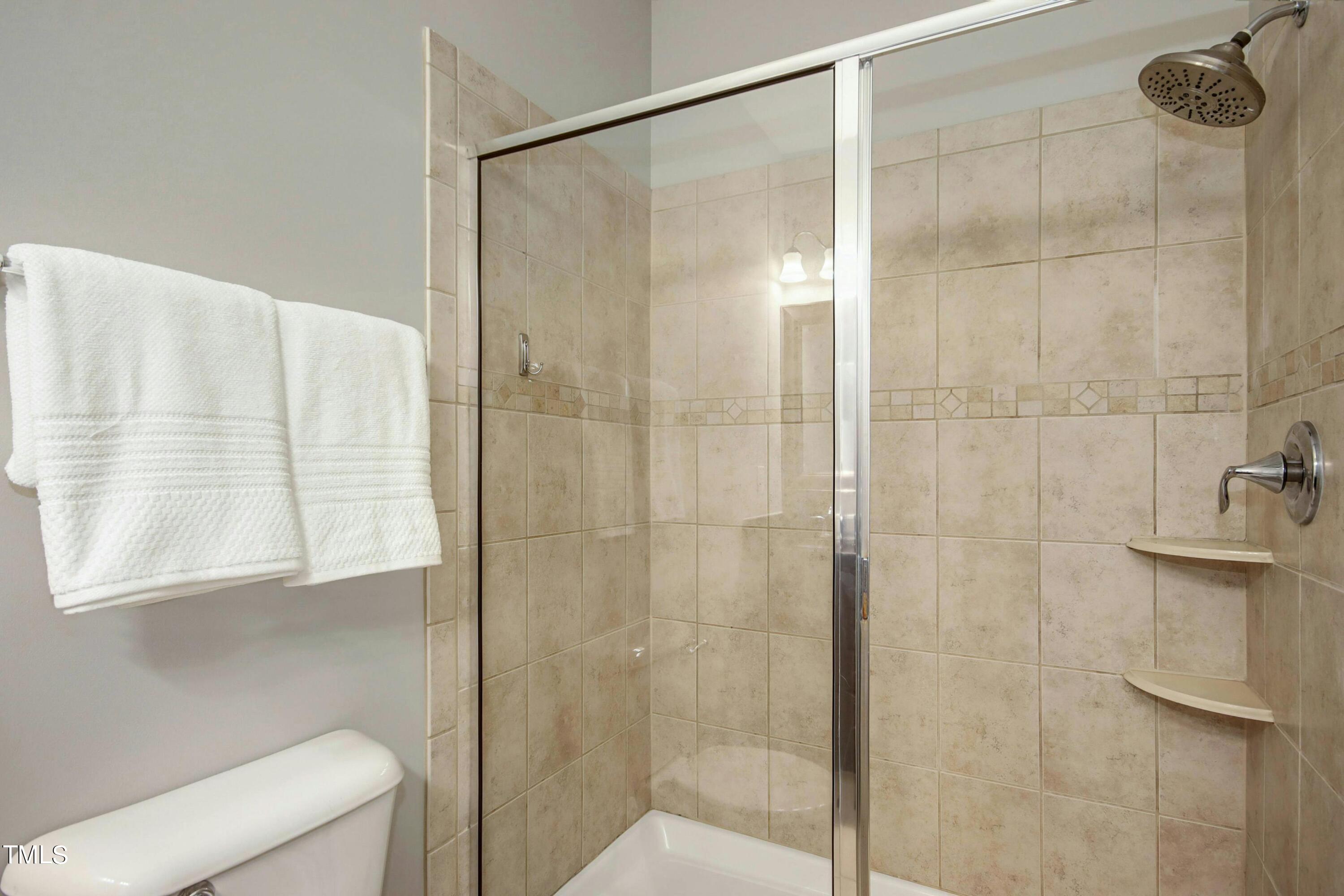 1418 Ardara Lane Raleigh, NC 27607 - Photo 22 of 34 a bathroom with a shower and a sink