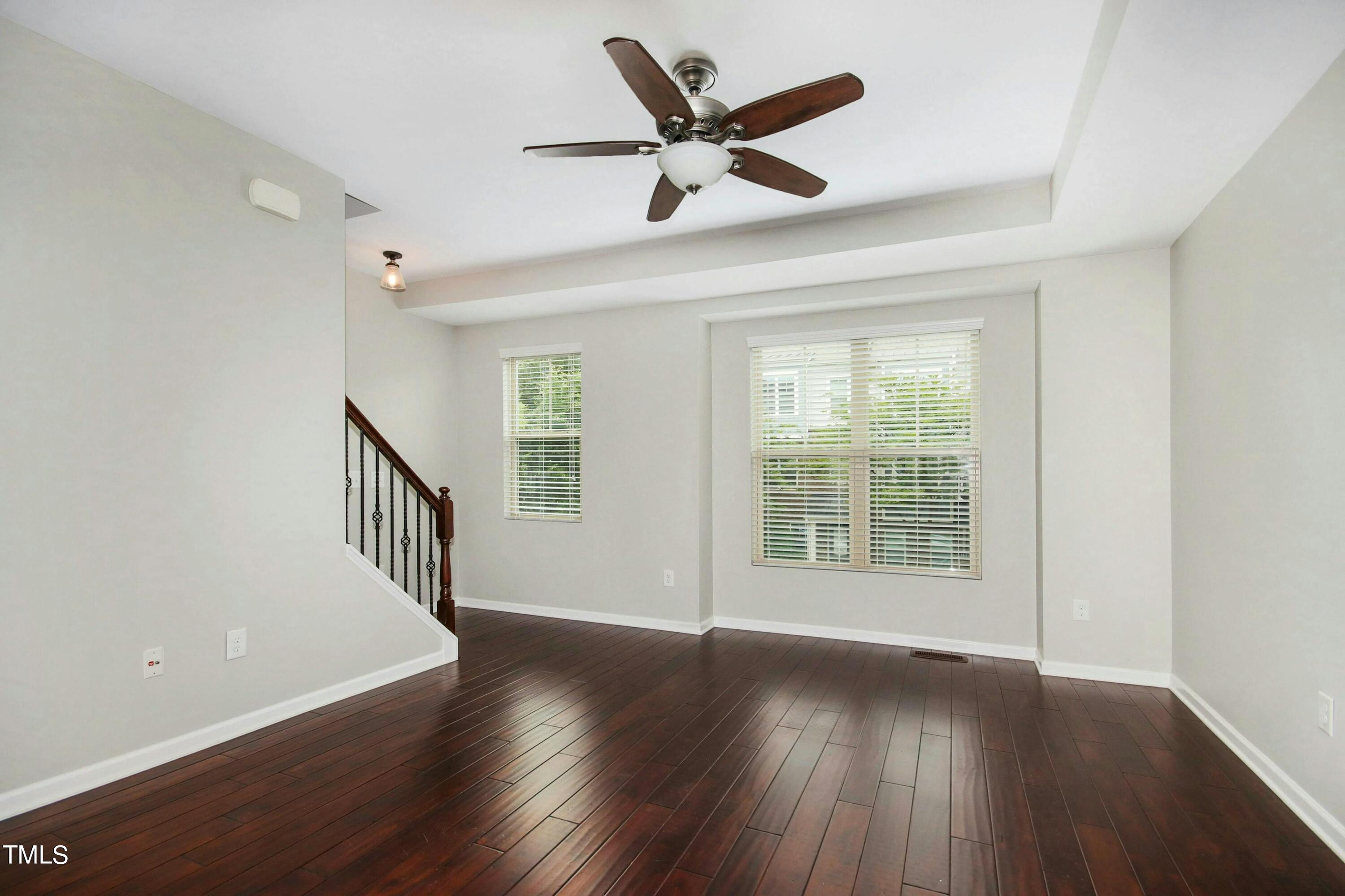 1418 Ardara Lane Raleigh, NC 27607 - Photo 6 of 34 a view of an empty room with wooden floor and a window
