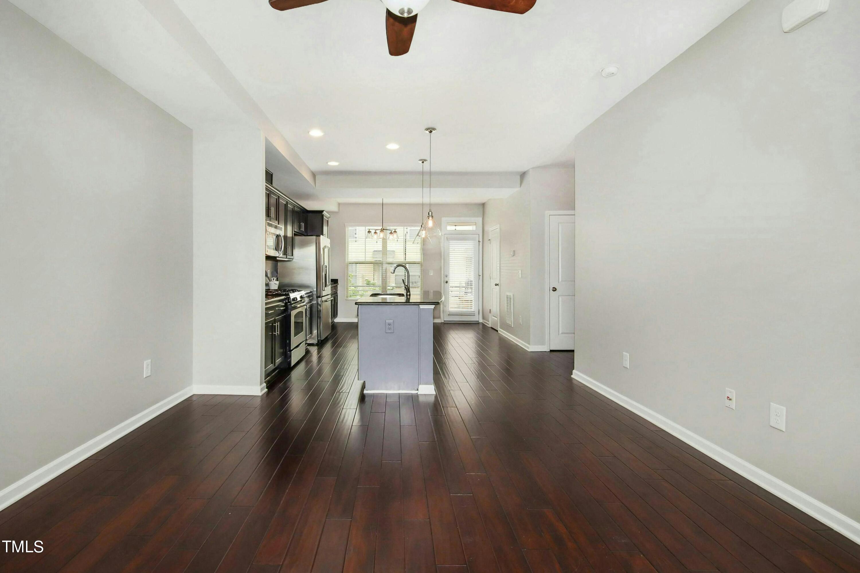 1418 Ardara Lane Raleigh, NC 27607 - Photo 9 of 34 an empty room with wooden floor and windows