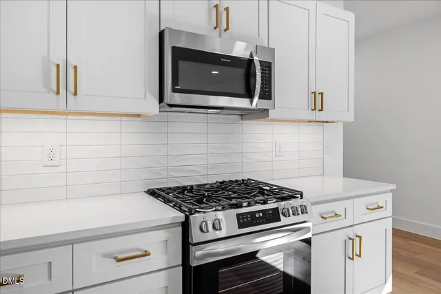 a stove top oven sitting inside of a kitchen