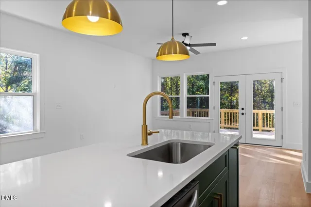 a kitchen with a sink a counter space and a window