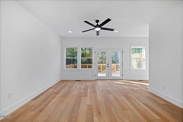 a view of a livingroom with a ceiling fan and window
