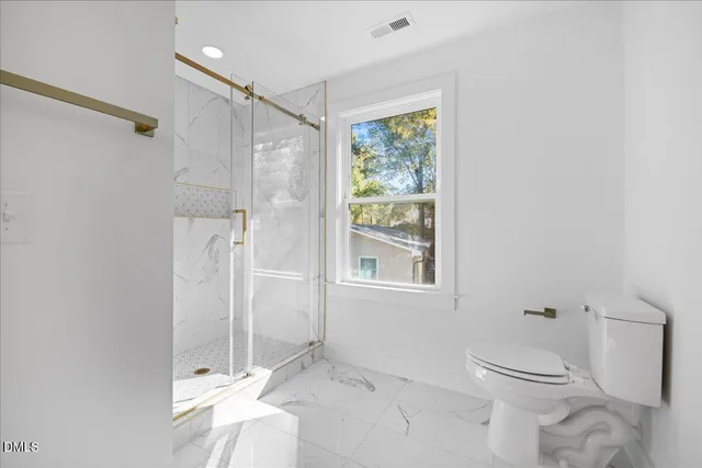 a bathroom with a toilet sink and shower