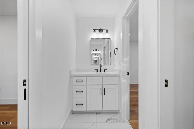 a bathroom with a sink a vanity and a mirror