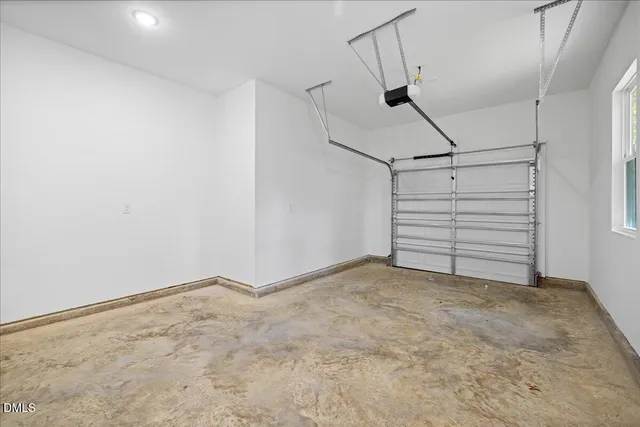 a view of a brick house with a small yard and furniture