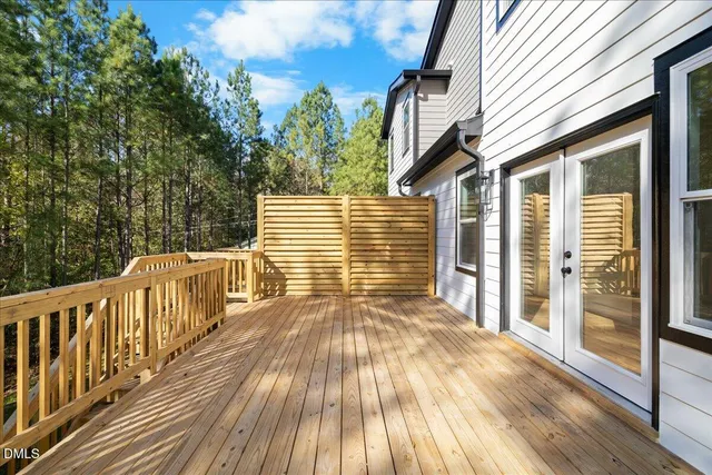 a view of a patio with couches table and chairs and potted plants