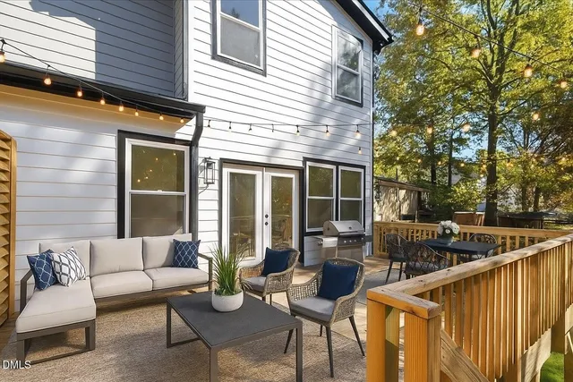 a view of balcony with wooden fence and floor to ceiling window