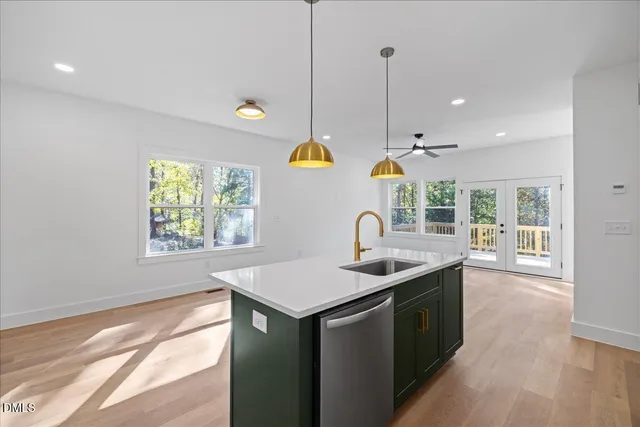 a kitchen that has a sink a window and stainless steel appliances