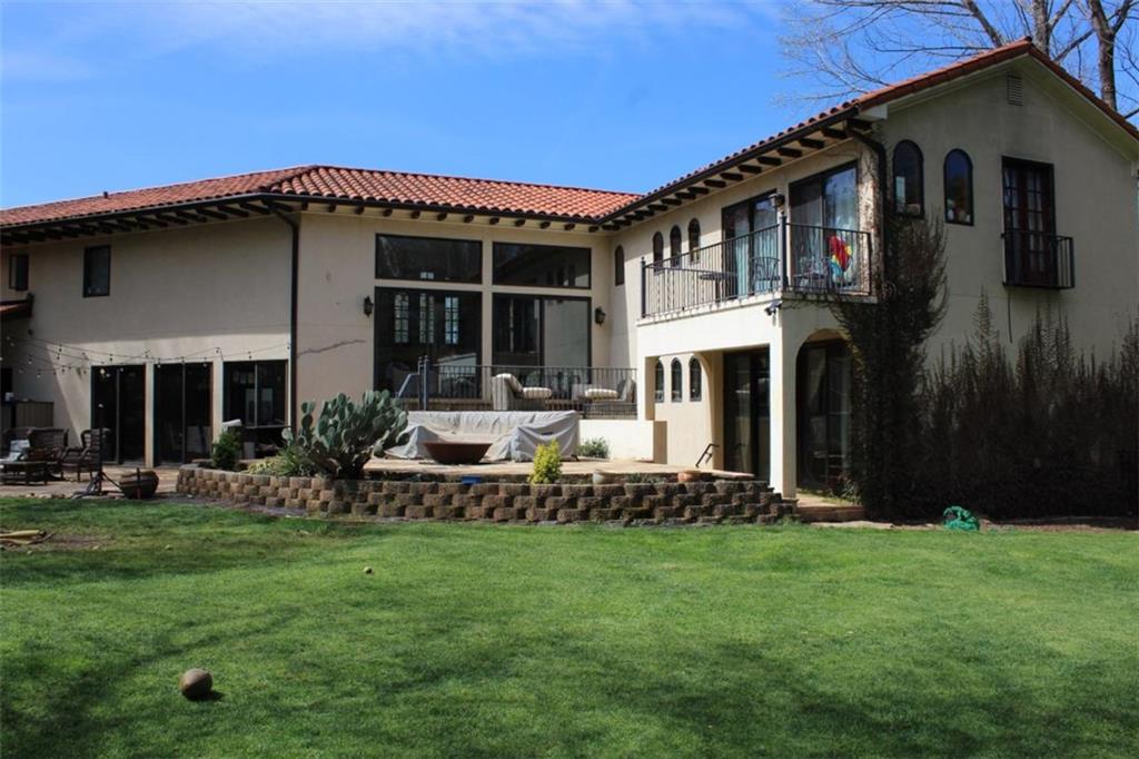 413 Spring House Cove Northeast Atlanta, GA 30307 - Photo 6 of 9 a front view of house with yard and outdoor seating