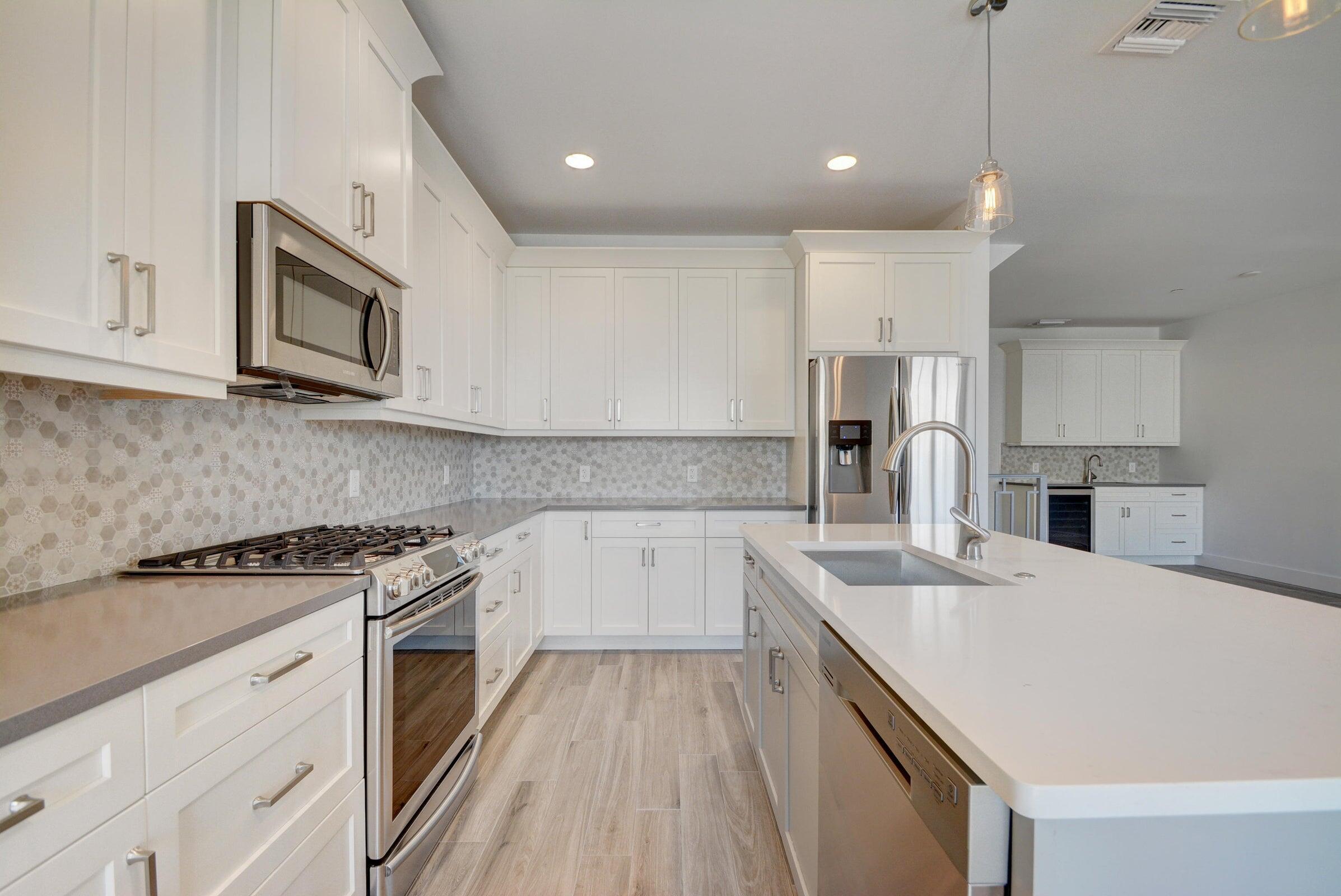 3770 County Line Road, Unit C2 Tequesta, FL 33469 - Photo 13 of 27 a kitchen with a sink a stove and oven