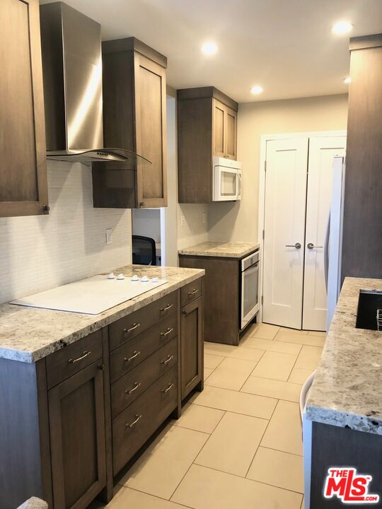 1250 North Kings Road, Unit 506 West Hollywood, CA 90069 - Photo 12 of 22 a bathroom with a granite countertop sink and a mirror