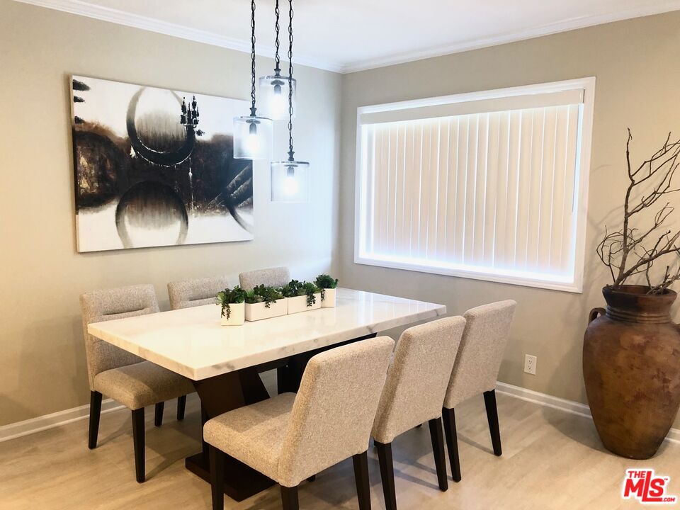 1250 North Kings Road, Unit 506 West Hollywood, CA 90069 - Photo 14 of 22 a view of a dining room with furniture and wooden floor