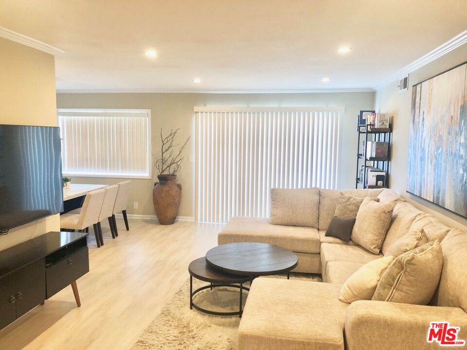 1250 North Kings Road, Unit 506 West Hollywood, CA 90069 - Photo 2 of 22 a living room with furniture and a large window