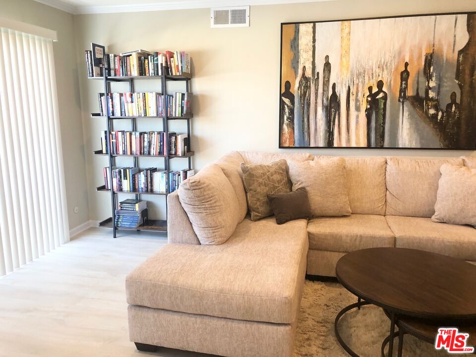 1250 North Kings Road, Unit 506 West Hollywood, CA 90069 - Photo 4 of 22 a living room with furniture and a book shelf