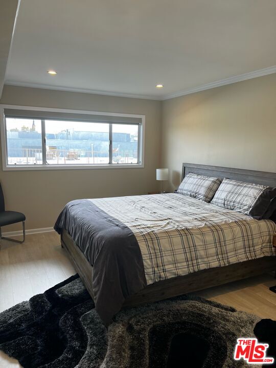 1250 North Kings Road, Unit 506 West Hollywood, CA 90069 - Photo 5 of 22 a bedroom with a bed and a window